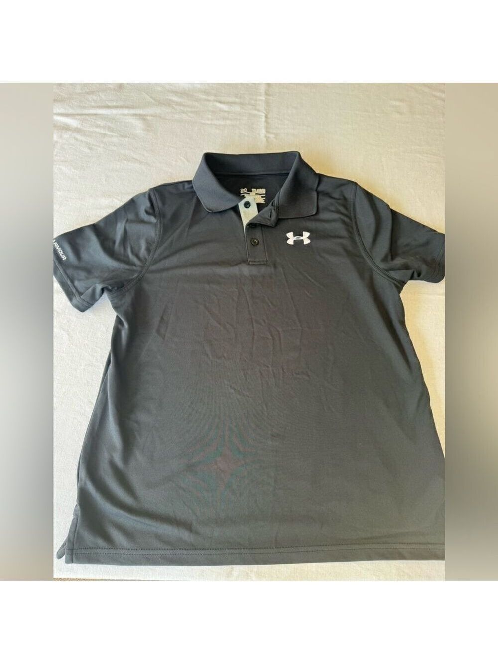 Under Armour short sleeve polo shirt.